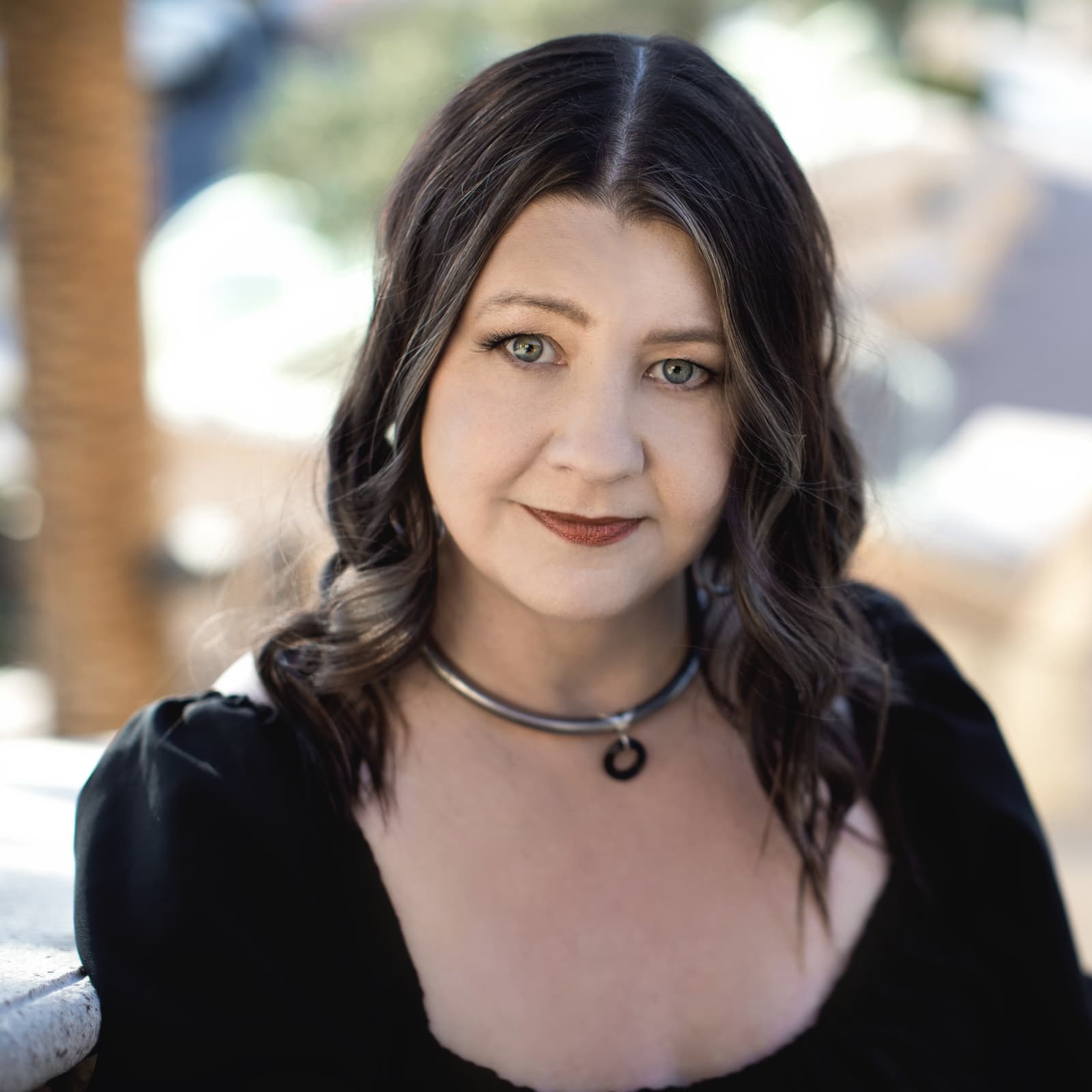 Luna McNally photographed outdoors in soft light, looking directly at the camera